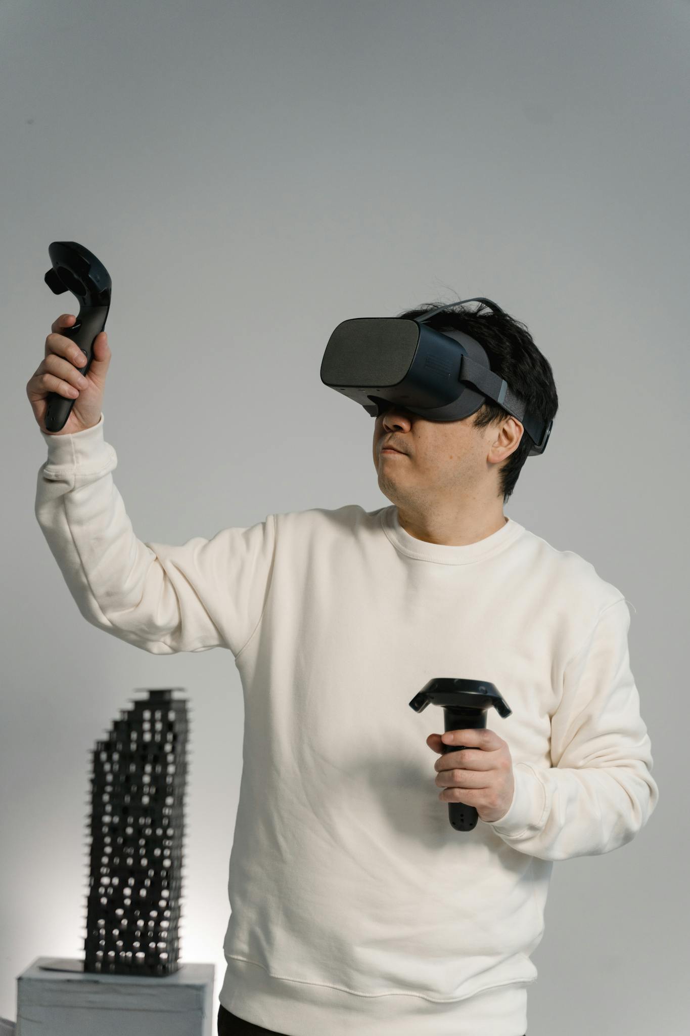 Adult man enjoying an immersive virtual reality gaming session with VR headset and controllers indoors.